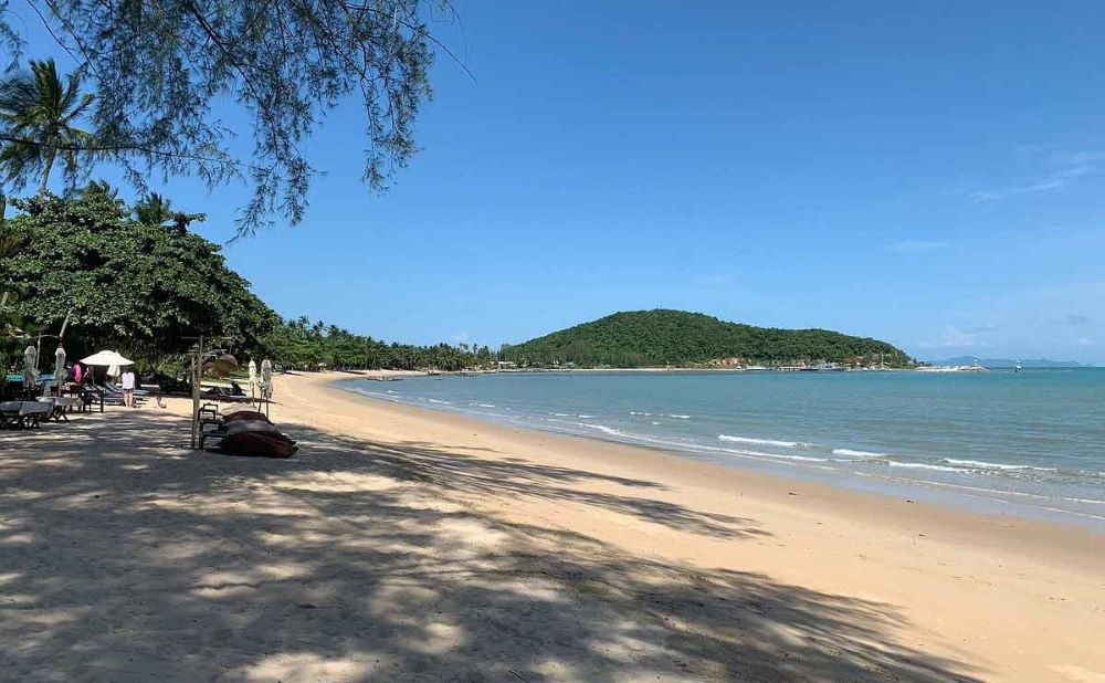beach with chairs and beach bed on the sand