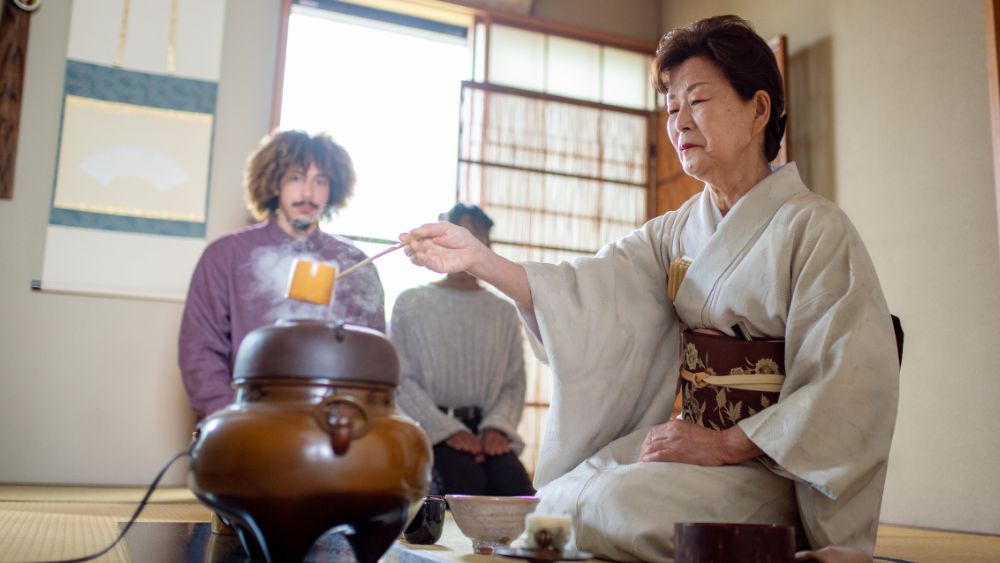 woman preparing traditional tea for visitors - best things to do in Tokyo