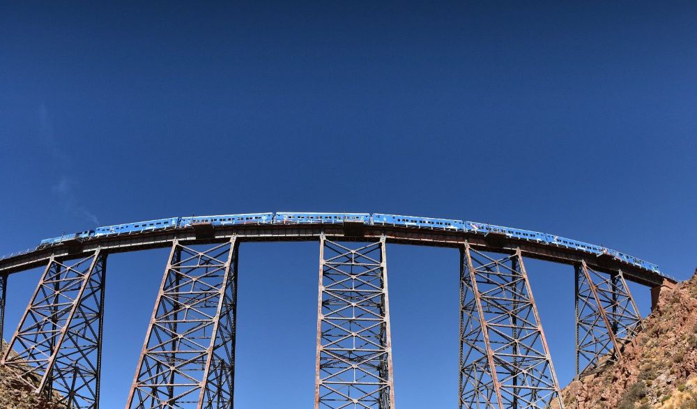 blue train in a high railway