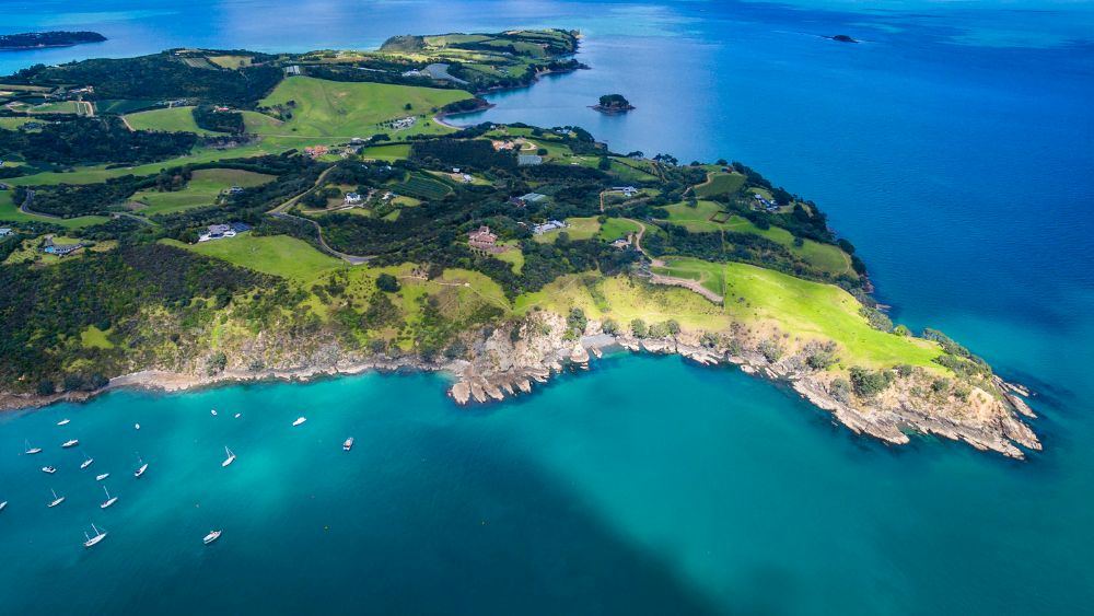aerial view of an island surrounded by blue ocean