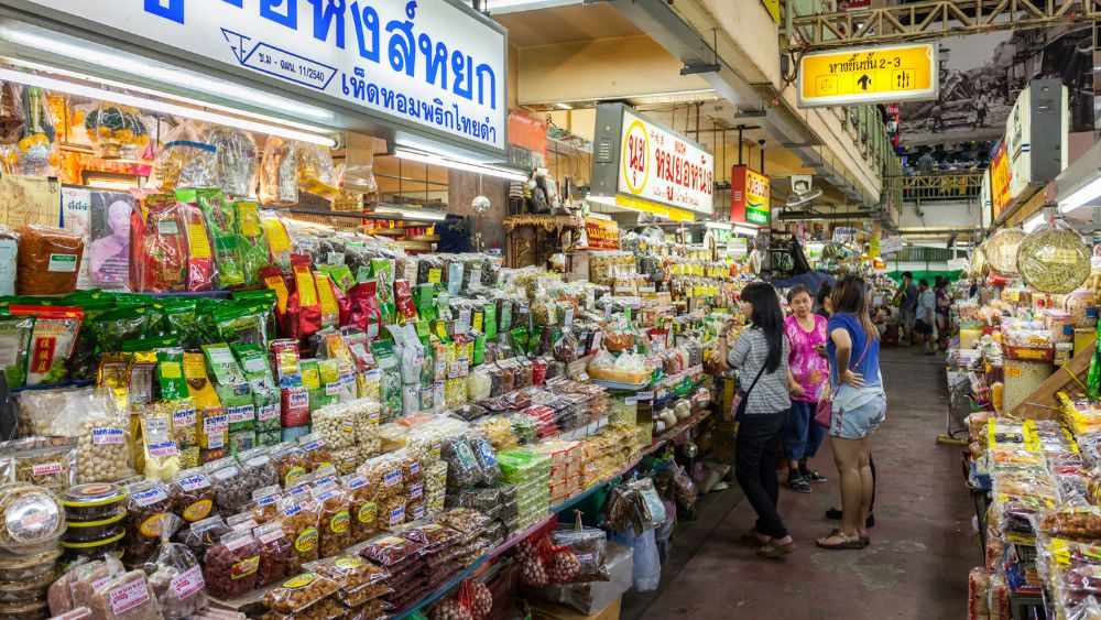 woman chatting in  market with variety of display product