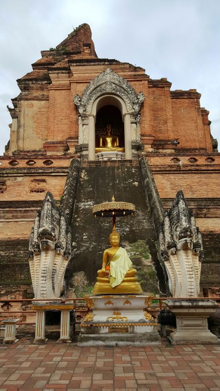 golden buddha in the middle of a ruin like structure- chiang mai temples