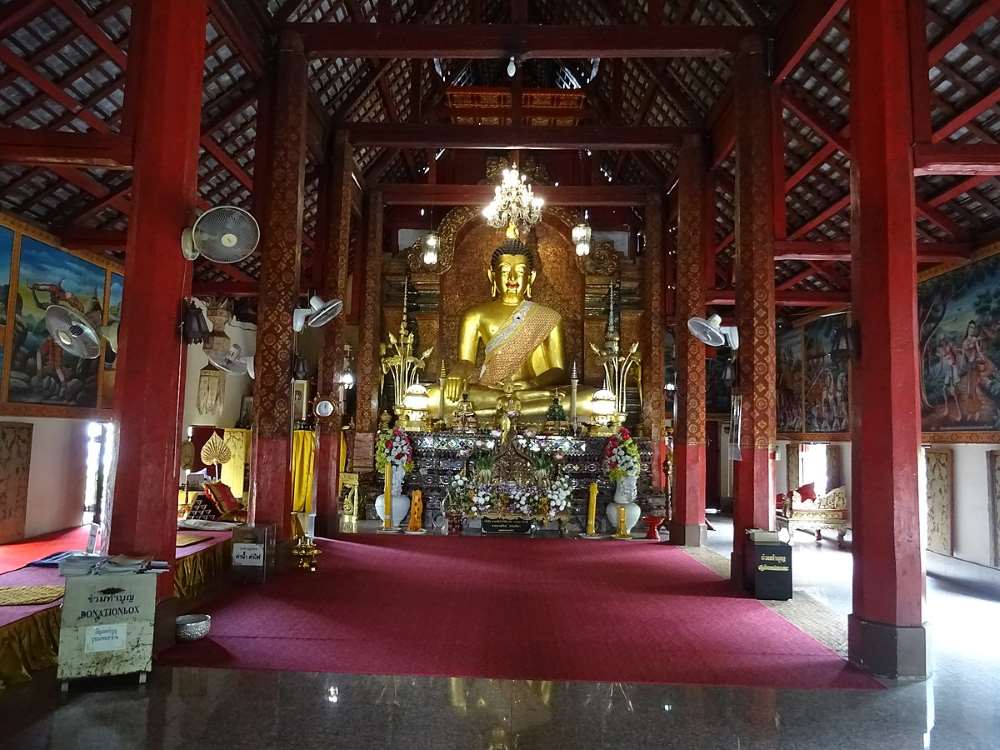 one big golden buddha in the middle inside the temple - chiang mai temples