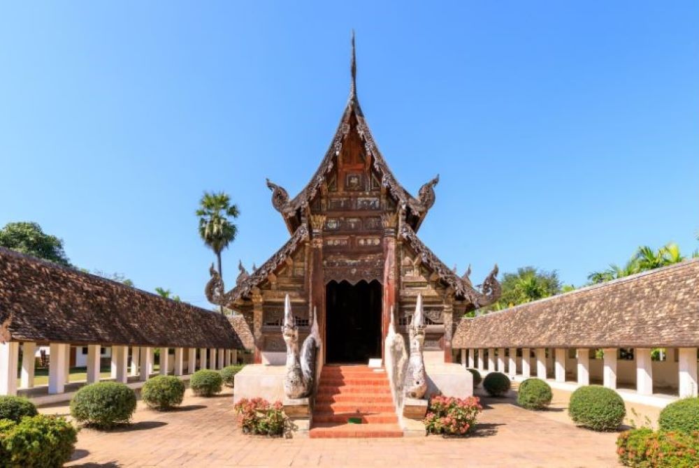 brown roof temple surrounded by pathway - chiang mai temples