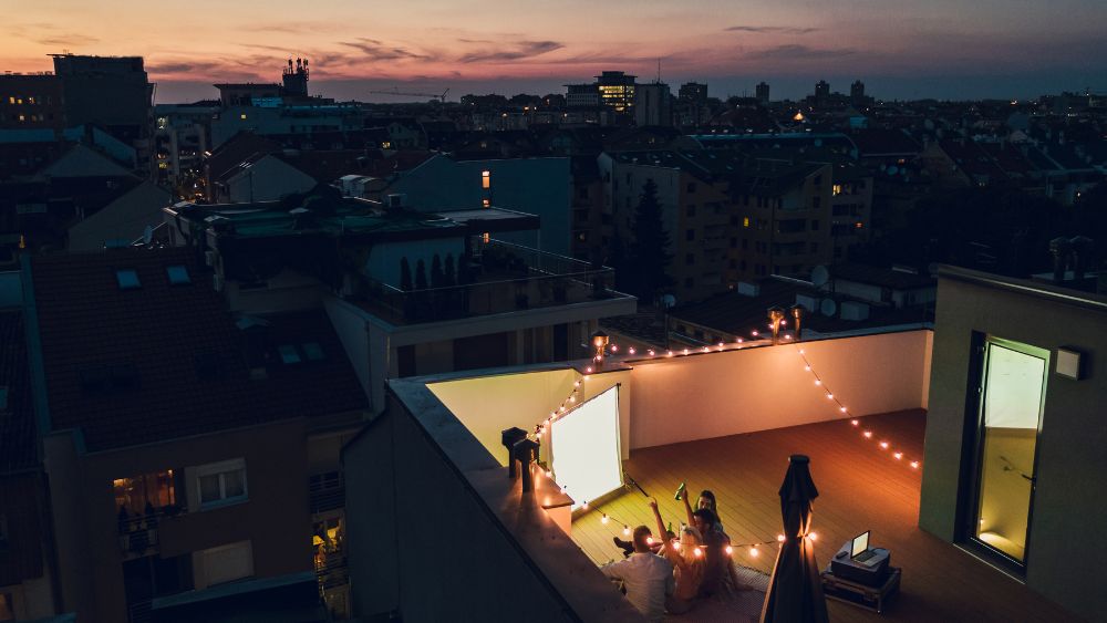 group of people in a rooftop watching cinema