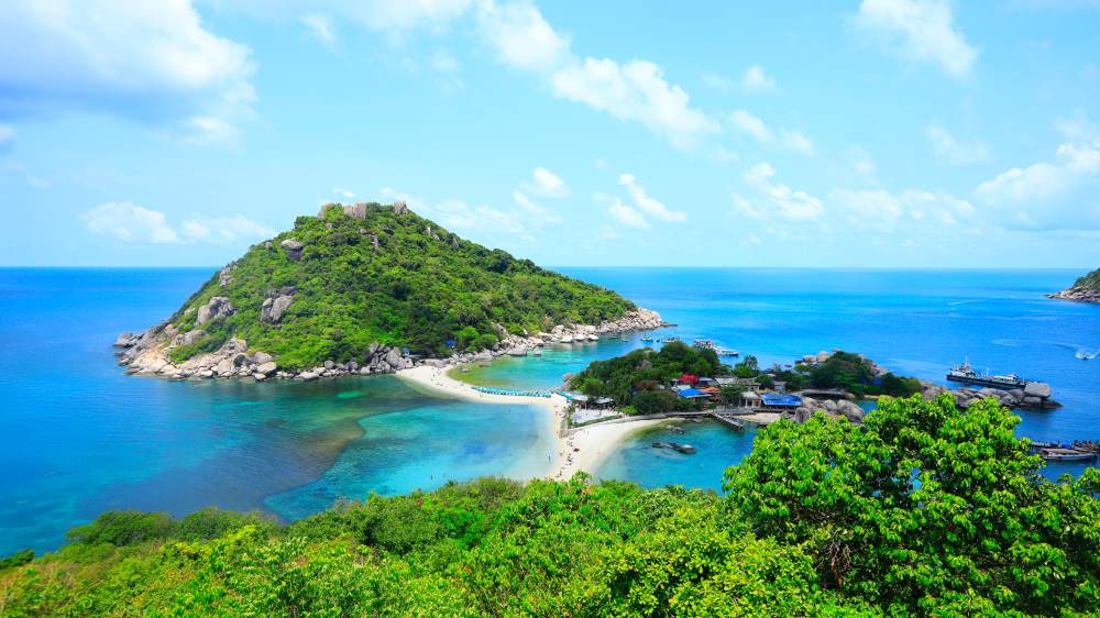 green lushy island in the middle of body of water -thailand digital nomad visa