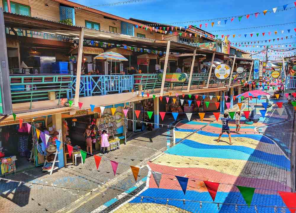 street view full of colorful banners and stalls in the side- thailand digital nomad visa