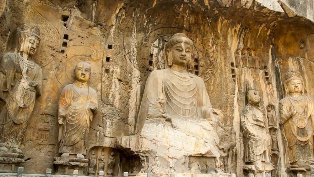 large statues of buddha in a cave - Oldest Cities in the World to Visit in 2025