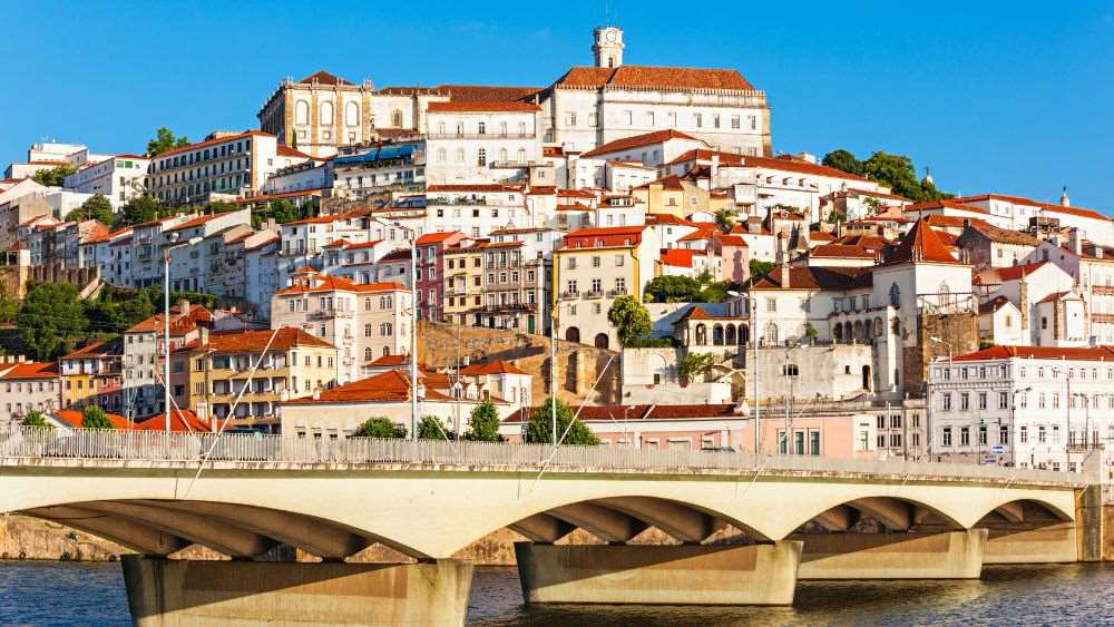 old structure houses near the bridge - Oldest Cities in Europe to Visit in 2025