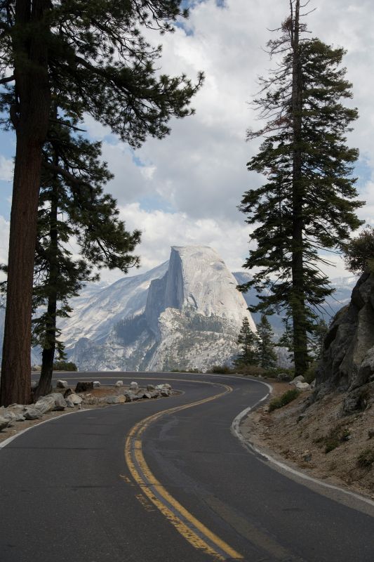 highway road surrounded by trees and mountains - Best road trips in the world
